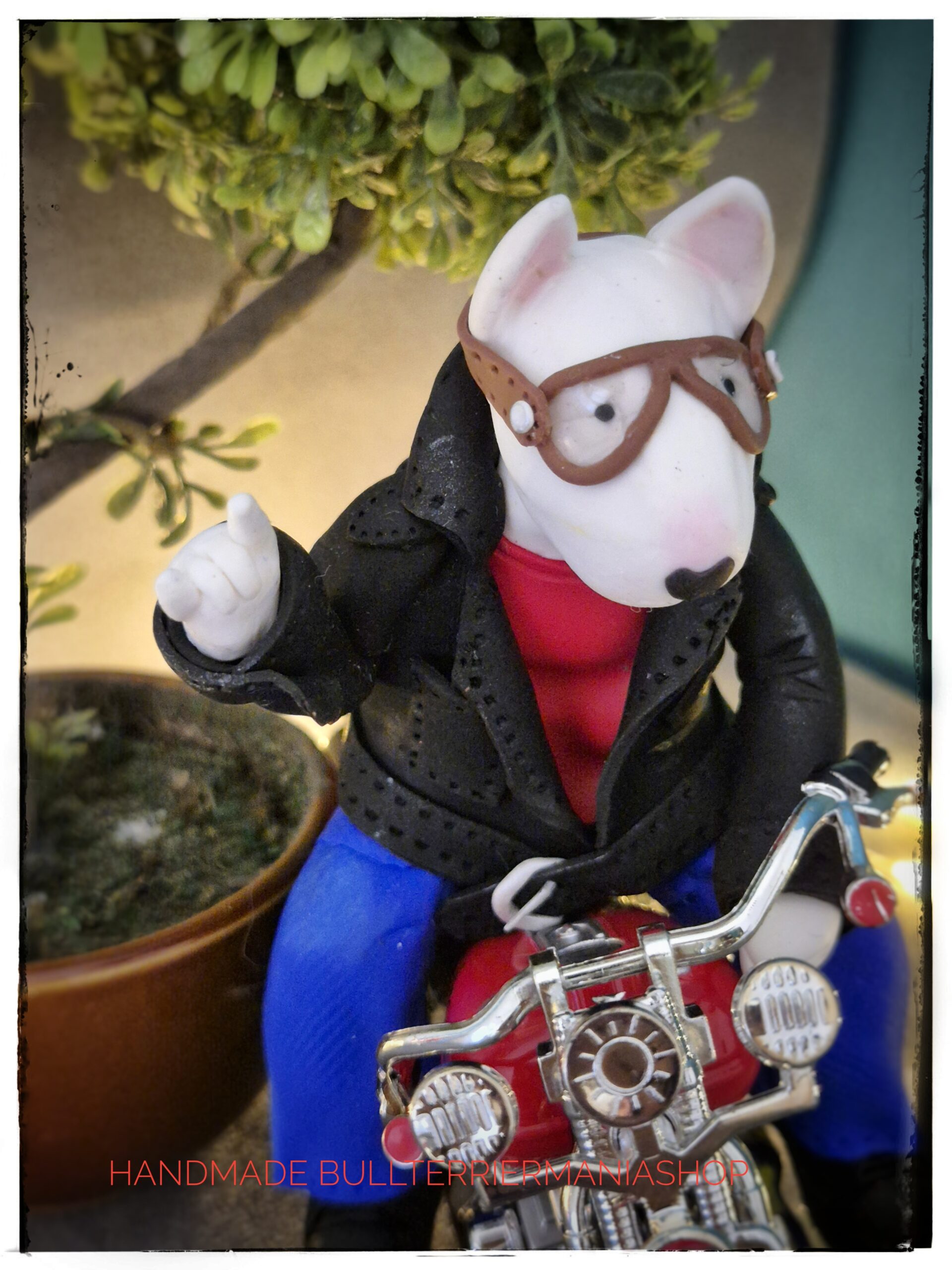 Detailed Bull Terrier biker sculpture with leather jacket and vintage goggles