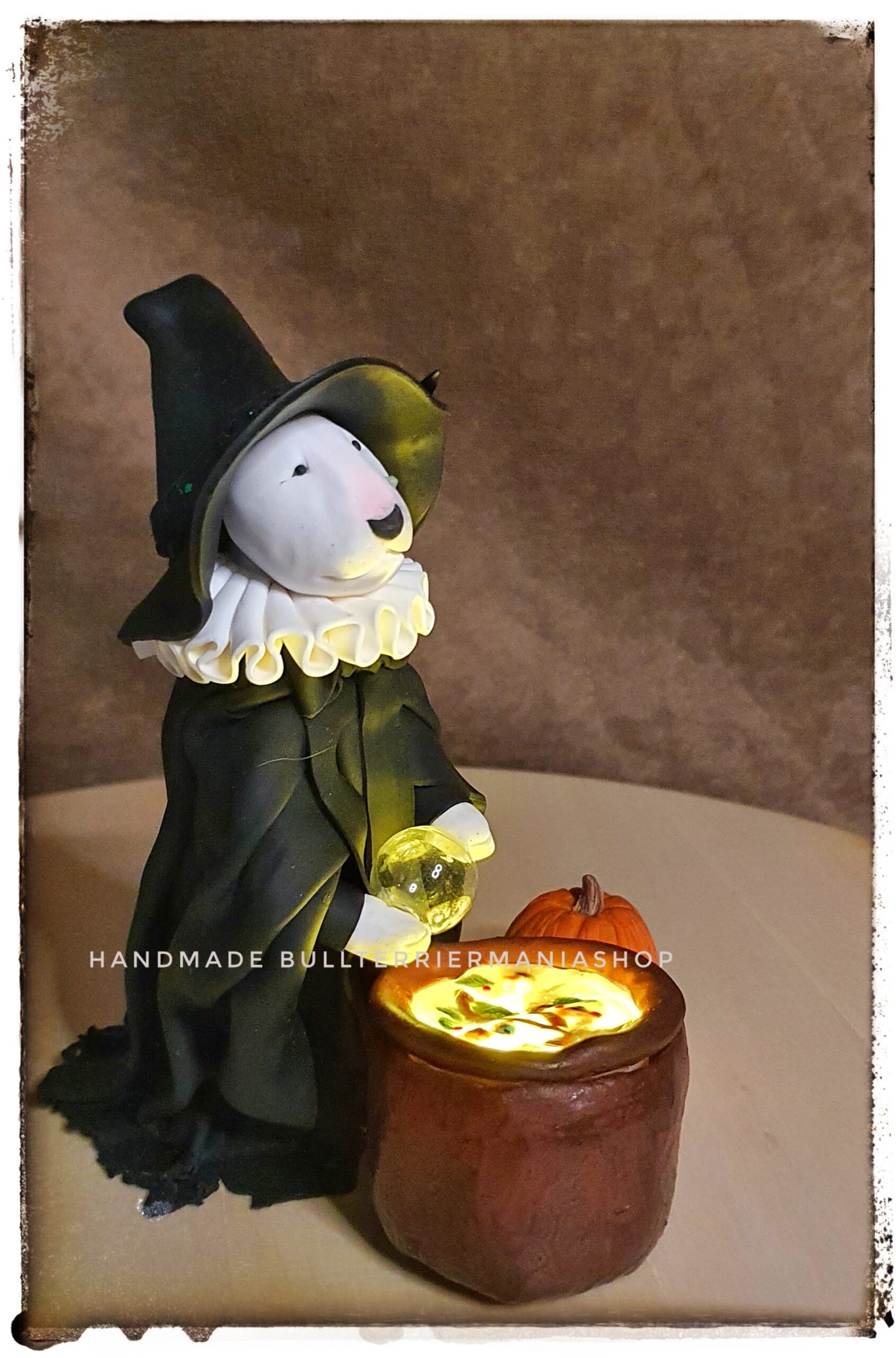 Bull Terrier witch figurine with crystal ball and Halloween pumpkin