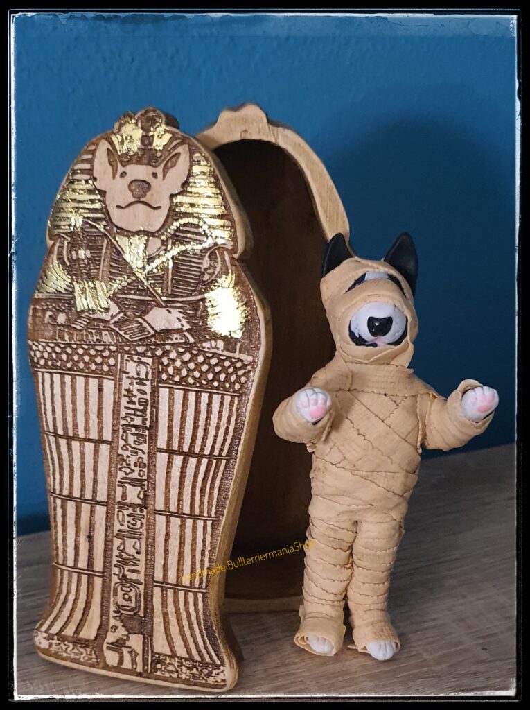 Handmade Bull Terrier mummy figurine with Egyptian sarcophagus. Unique polymer clay collectible and gift for Bull Terrier lovers and history enthusiasts.