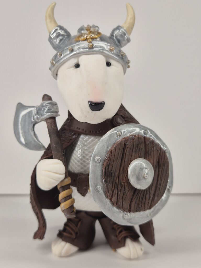 Handmade Viking Bull Terrier figurine holding an axe and shield with detailed Norse warrior armor