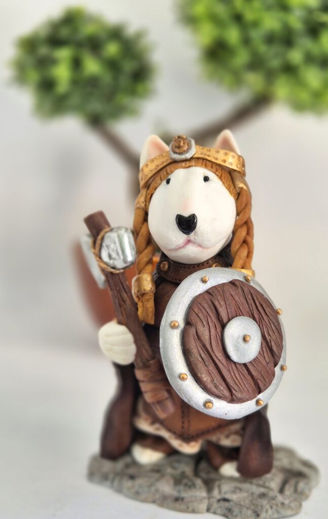 Female Viking Bull Terrier figurine holding an axe and shield