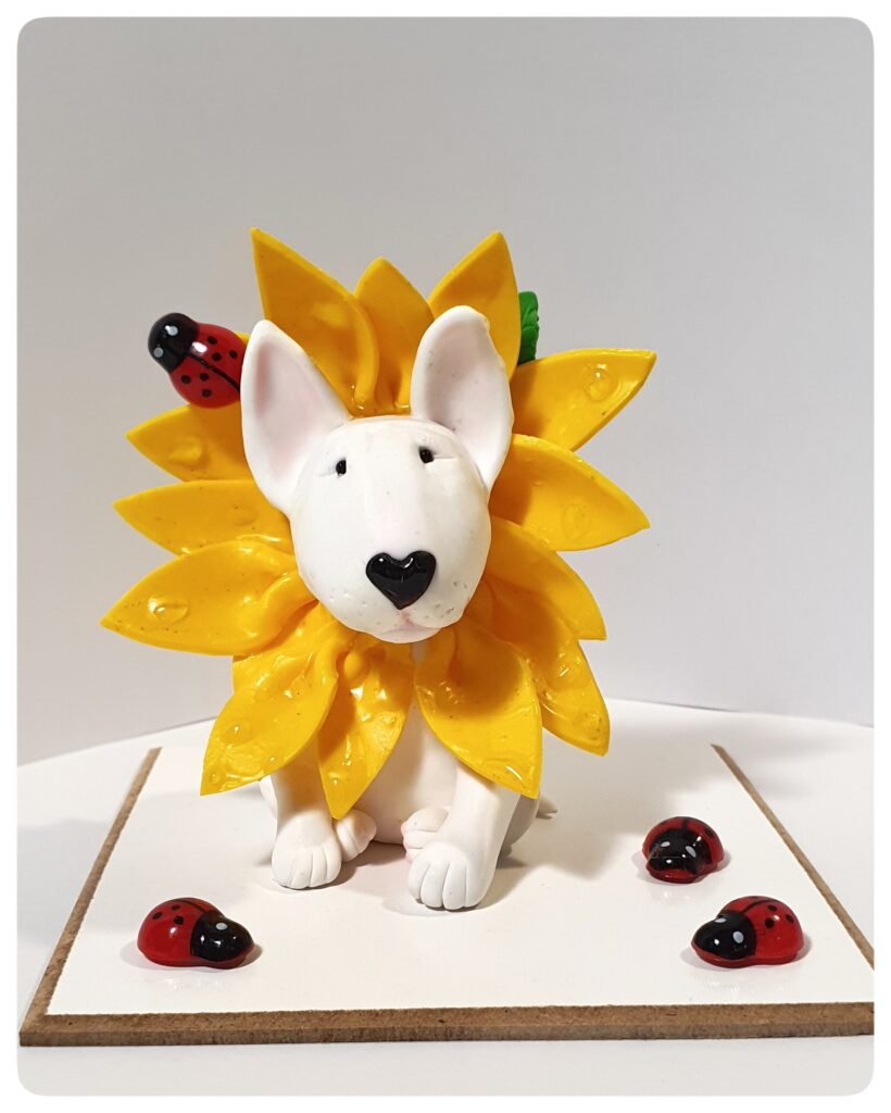 Handmade Bull Terrier sunflower figurine with bright yellow petals.