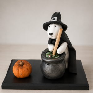Handmade Bull Terrier Witch Figurine stirring a magic cauldron.
