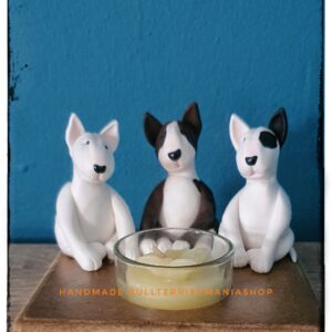 Bull Terrier candle holder with three Bull Terrier figurines around a tea light.