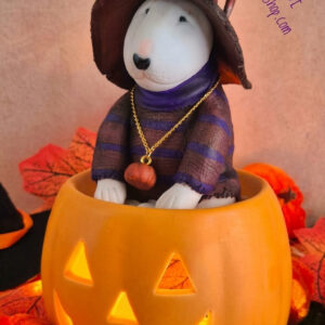 Handmade Bull Terrier Halloween figurine sitting inside a glowing jack-o'-lantern pumpkin